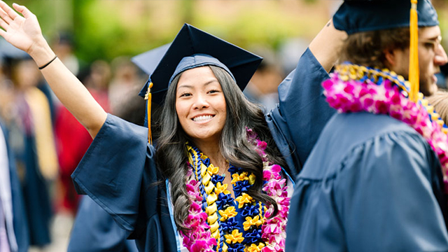 A student in graduation regalia.