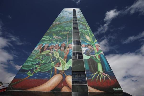 photo of a mural featuring indigenous women and tropical foliage