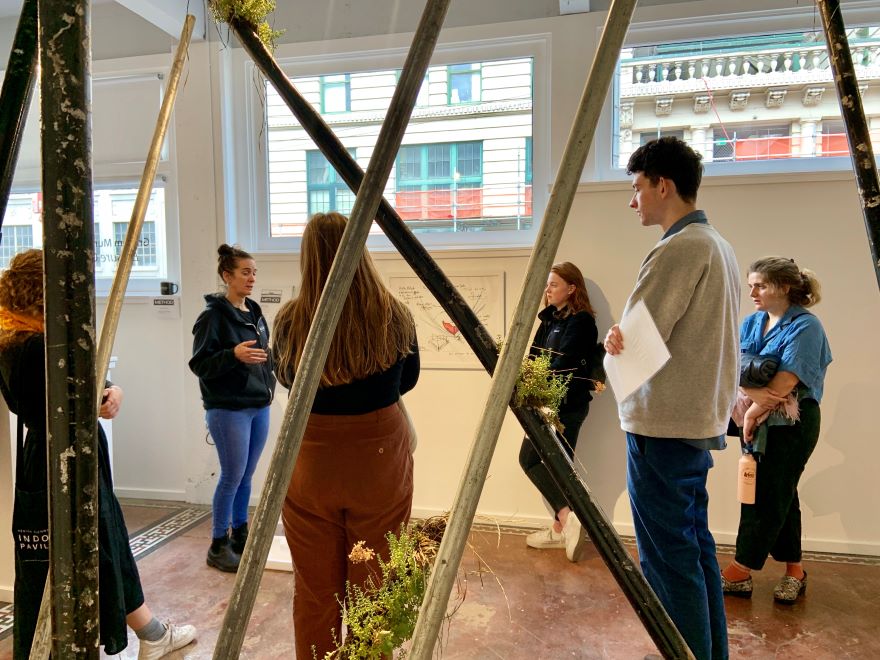 students gathered for a presentation from an artist