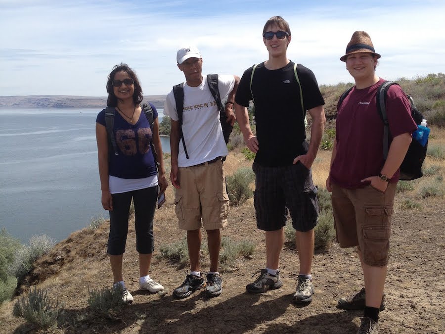 Students posing on top of cliff