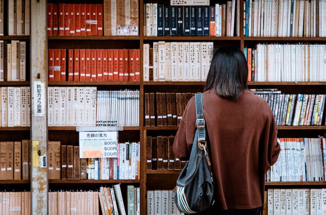 Student looking at books.