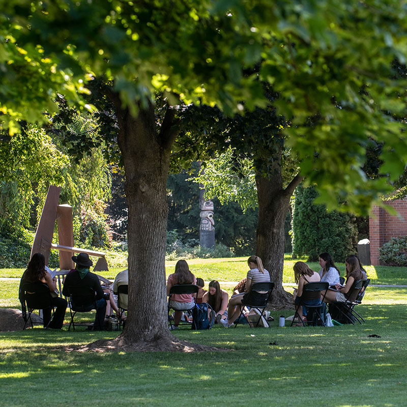 Students in class outdoors.