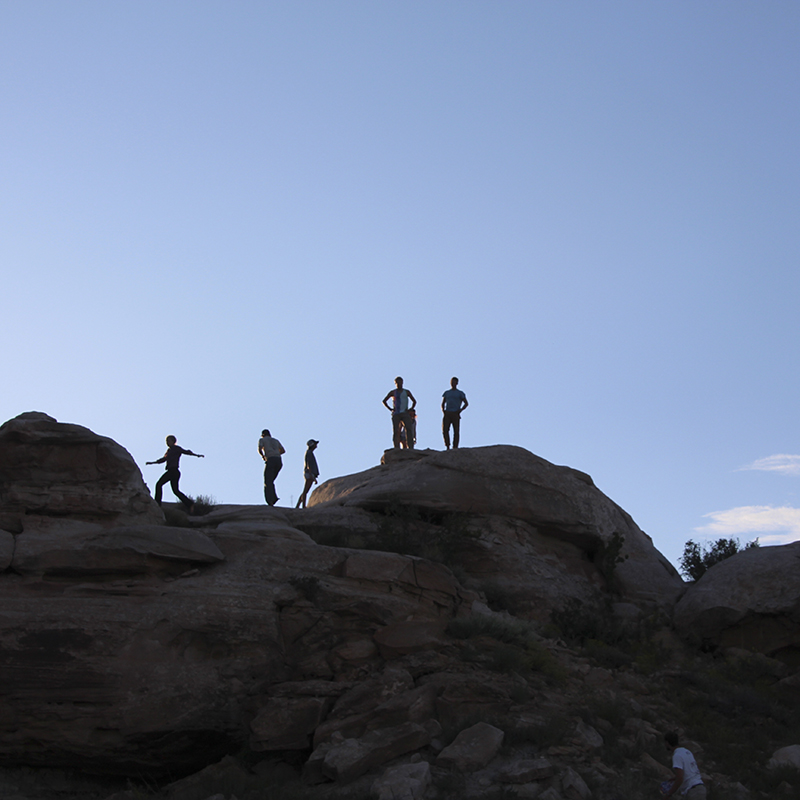 Students on rocks in the distance.