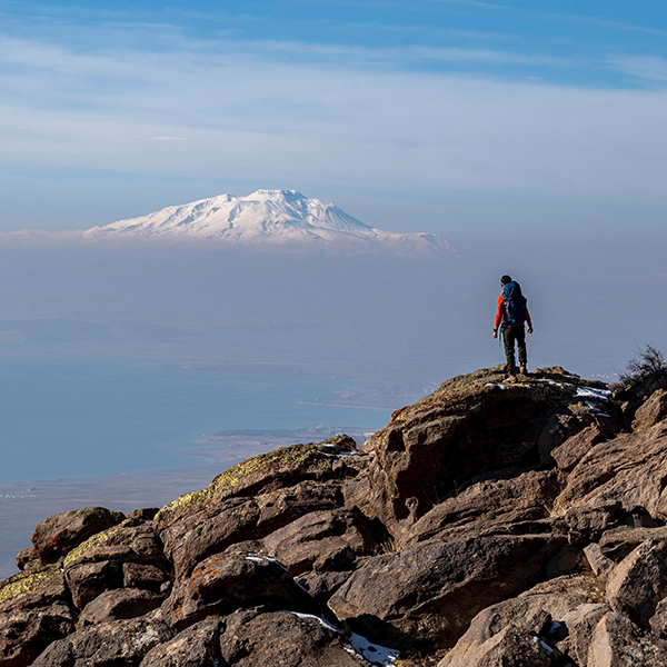 Hiker looking at mountain in the distance.