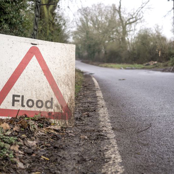 Flood sign on road.