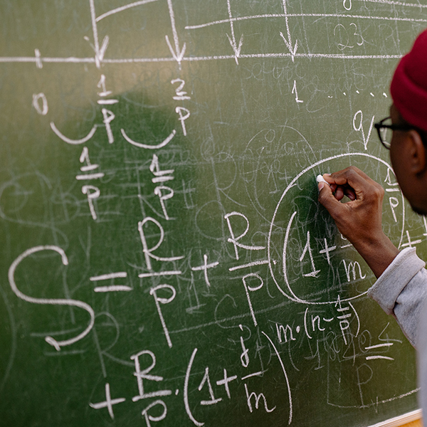 Writing equations on the chalkboard.