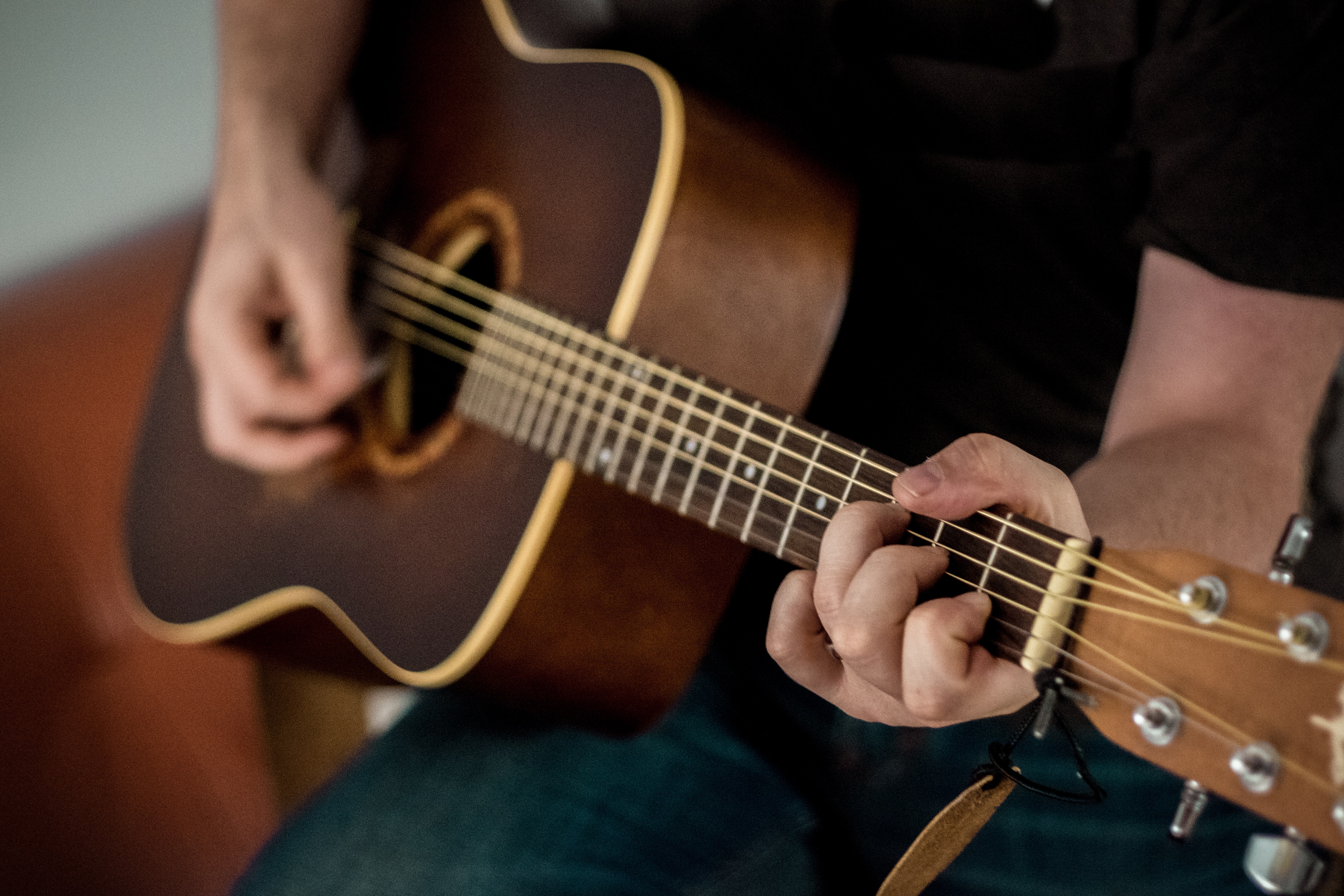 Playing acoustic guitar.