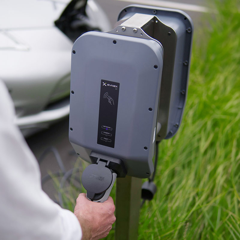 Someone about to use an EV charger for their vehicle.