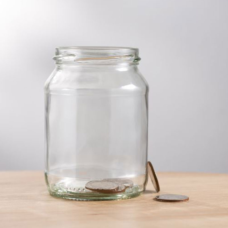 A jar with some coins inside of it.