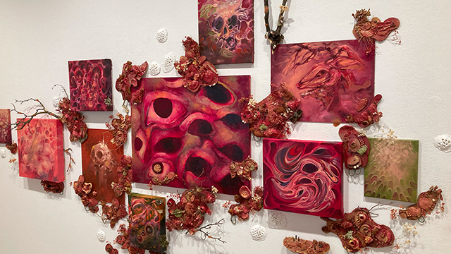 A collection of abstract artwork in predominantly dark red tones.