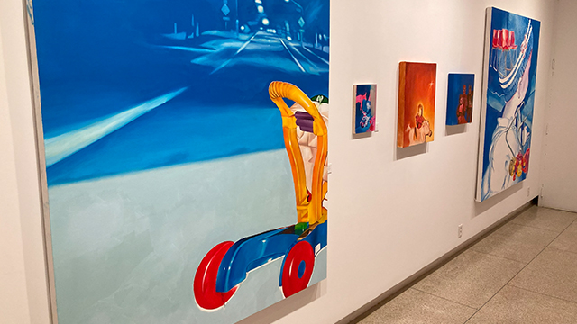 Several paintings in bright primary colors.