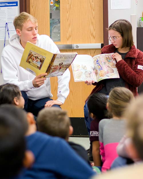 Gareth Jones '19 and Allie McCann '22 teach the lesson of Ruby Bridges to first graders at Edison Elementary during the 2019 Whitman Teaches the Movement Program in Walla Walla public schools.