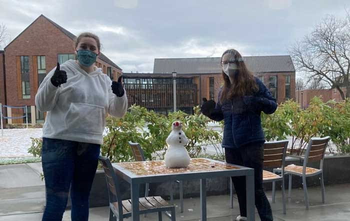 Zoe Perkins and friend standing outside.