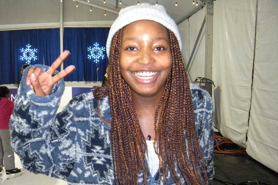 Hana Nandawula Bunnya giving the peace sign and smiling