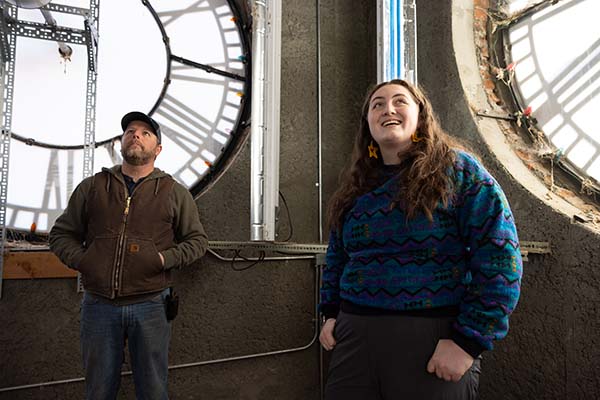 Zoe Perkins inside the clock tower looking up.