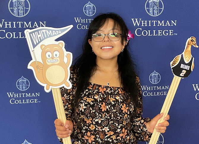 VSP visitor taking a picture with the Whitman College background.