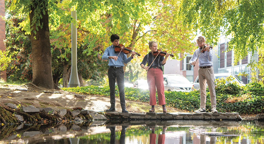 Students at College Creek playing string instruments