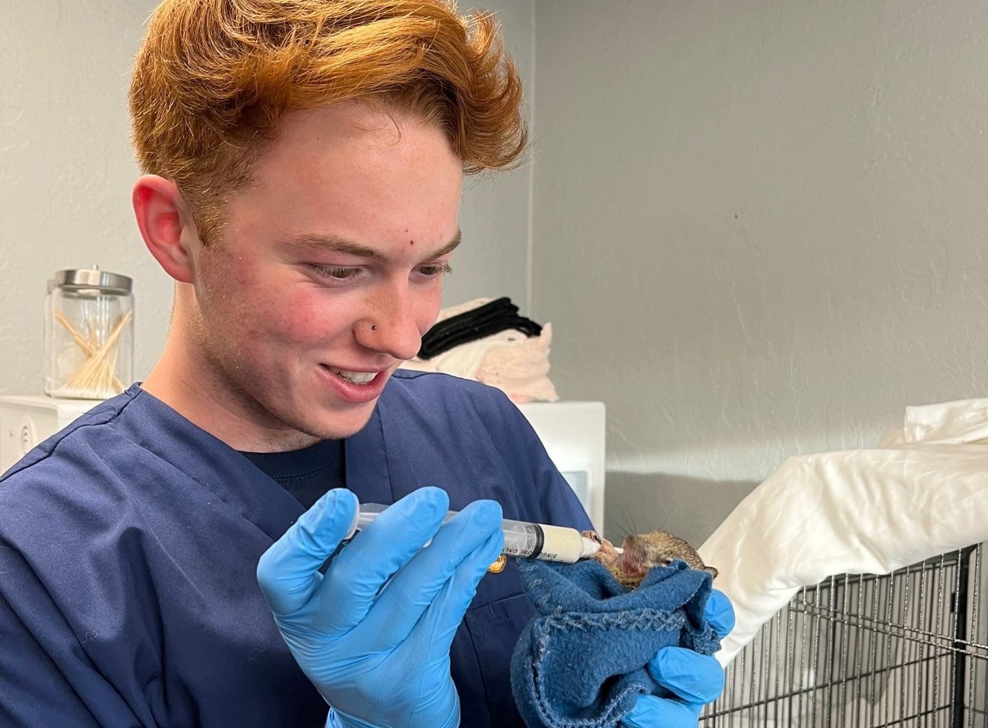 Alex Muller feeding a rescued squirrel.