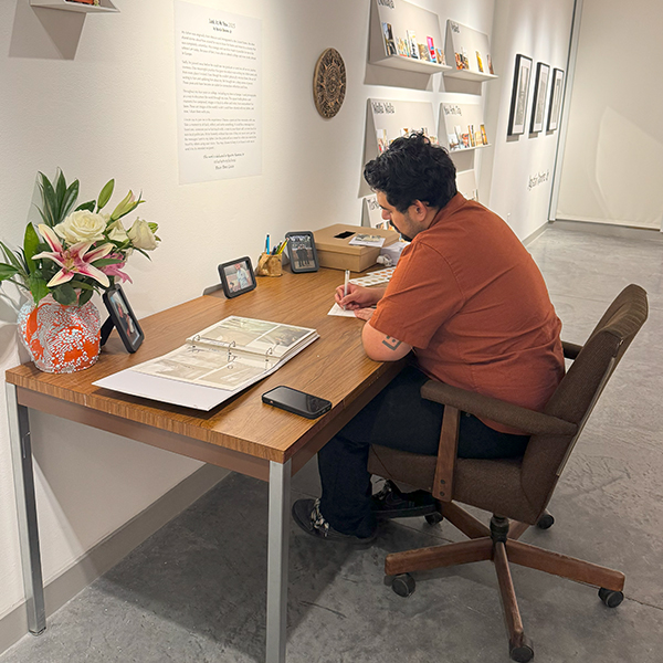 Image of Augi Ramirez Jr., sitting at a desk.
