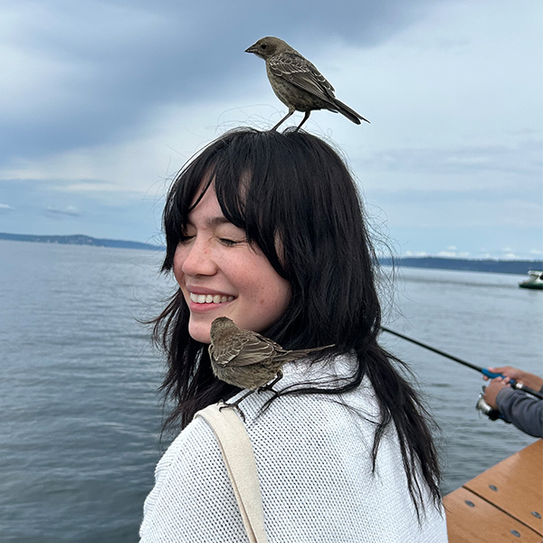 Image of Catherine Gallo with a bird on her head