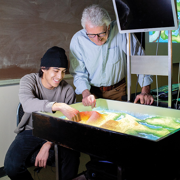 Faculty member Pat Spencer teaching geology with a student