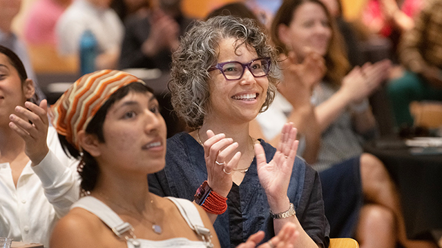 A crowd shot of people applauding at the 2023 Inclusive Excellence Awards ceremony.