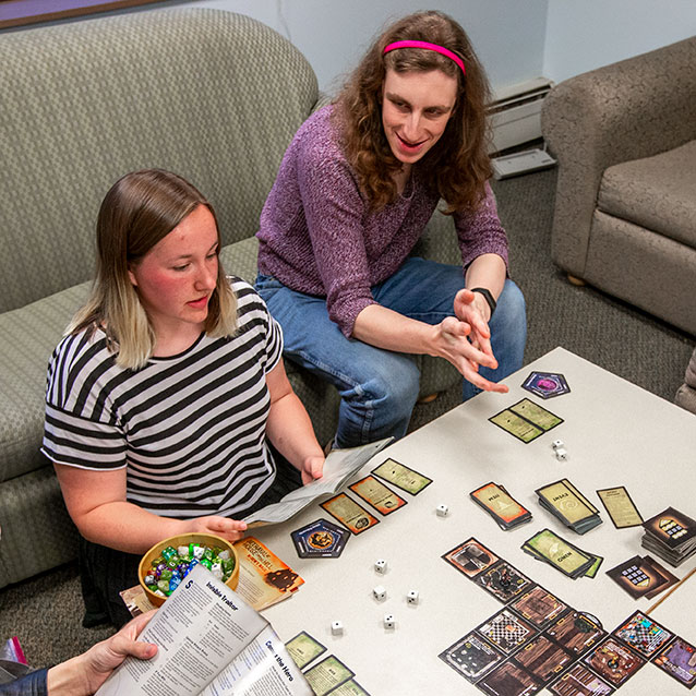 Students play a card game in the Tabletop Games club.