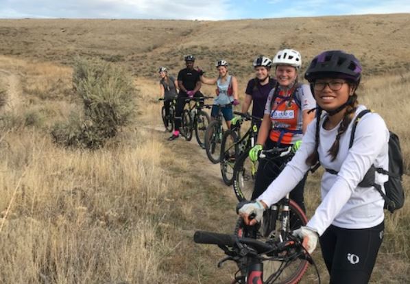 Mountain bikers in a wheat field trail.