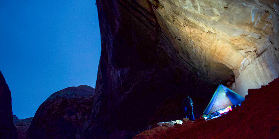 A tent with Whitman students in a canyon at night fall.