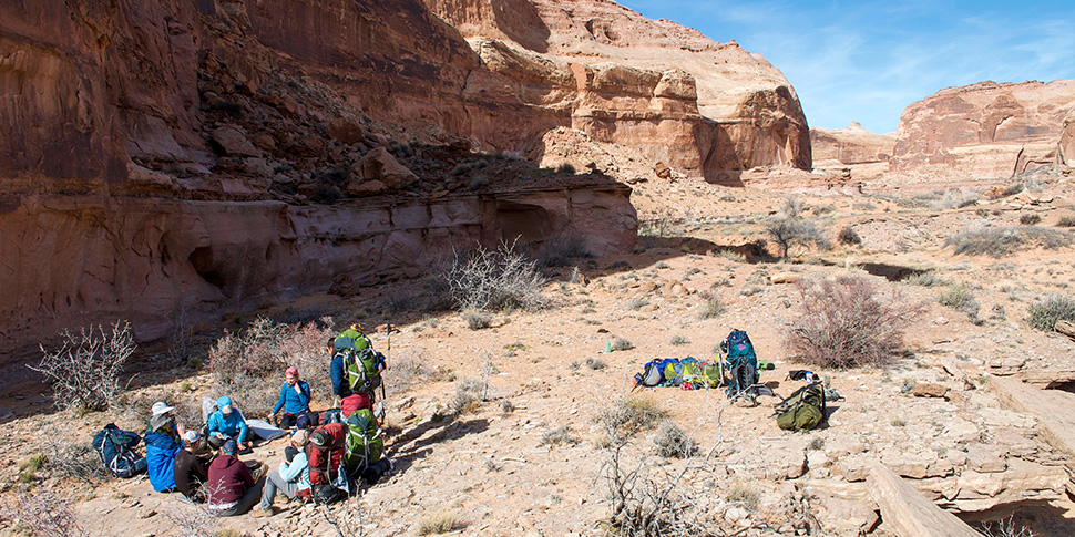 A tent with Whitman students in a canyon in the early morning.