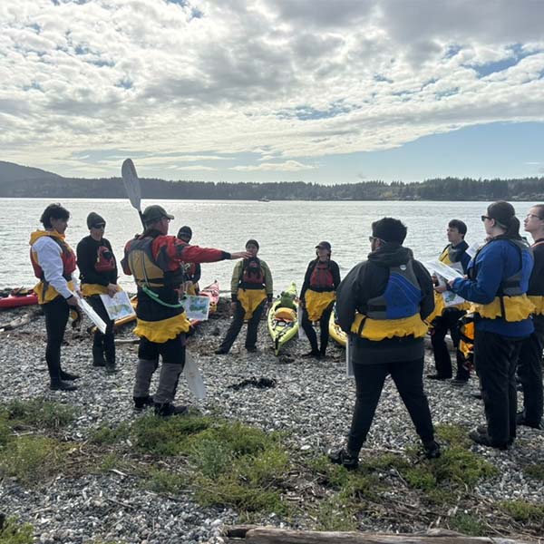 Kayakers preparing to enter the water.