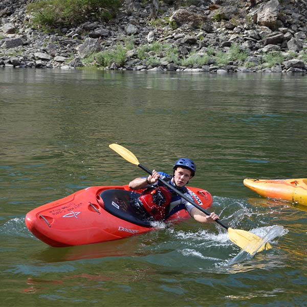 A kayaker practicing on a river.