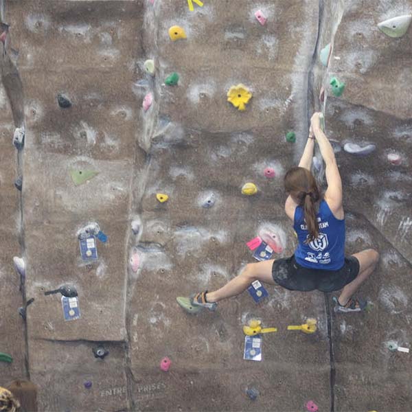 A rock climber on an indoor wall.