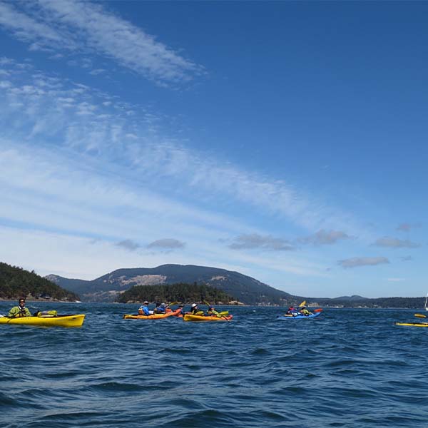 Kayaks on the open ocean waters.