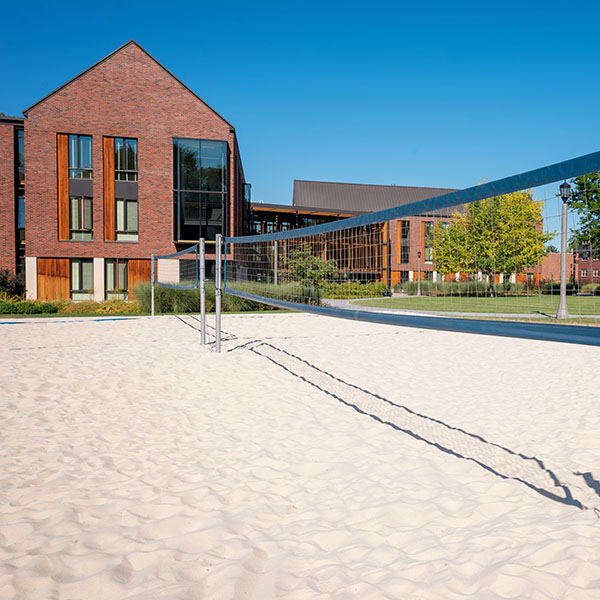 Outside of Stanton Hall with a volleyball sand court in the foreground