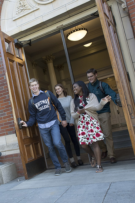 Four students walk out of a building