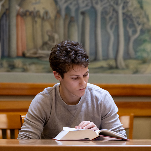 A student reading their book at Whitman College.