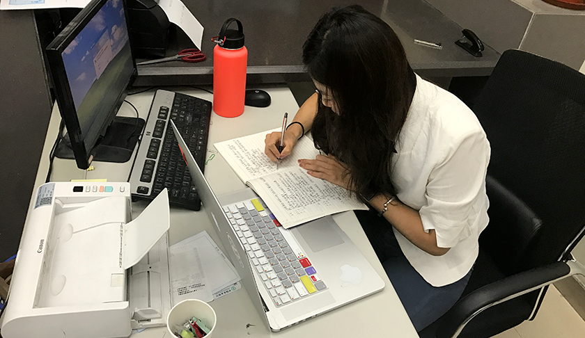 Linqi Sheng works on a computer at her internship with the Agricultural Bank of China. 