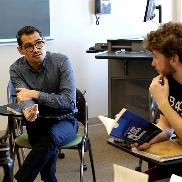 Aaron Aguilar-Ramirez teaches students in class.