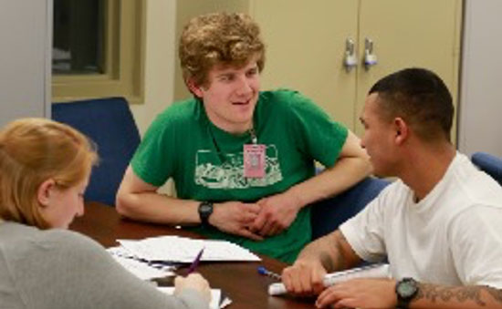 Students speaking with a prison inmate
