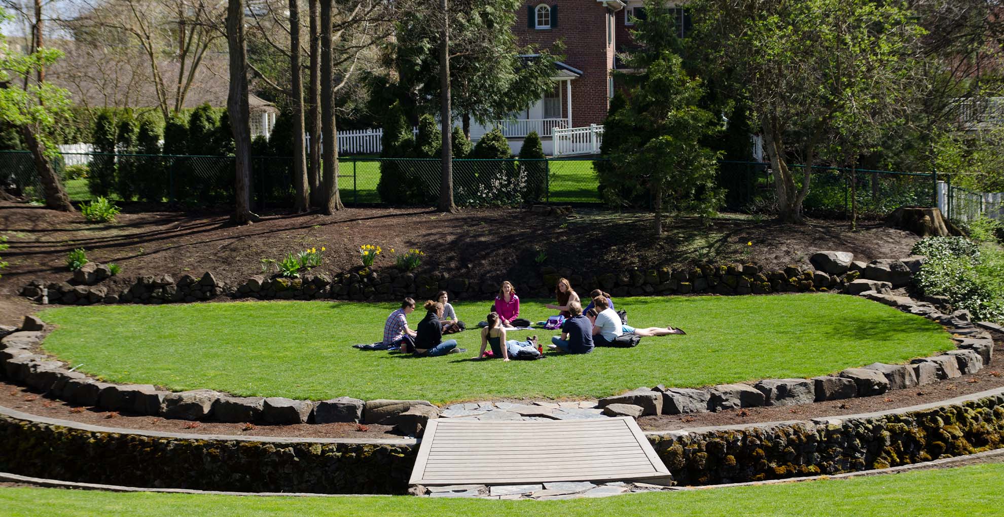 Students sitting in a circle at the amphitheatre.