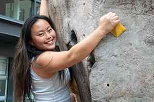 Wako Soma smiling on Whitman's climbing wall