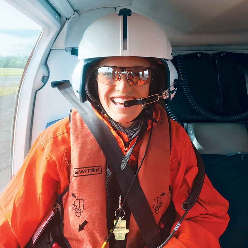 Erica Goad, wearing a helmet inside a helicopter.