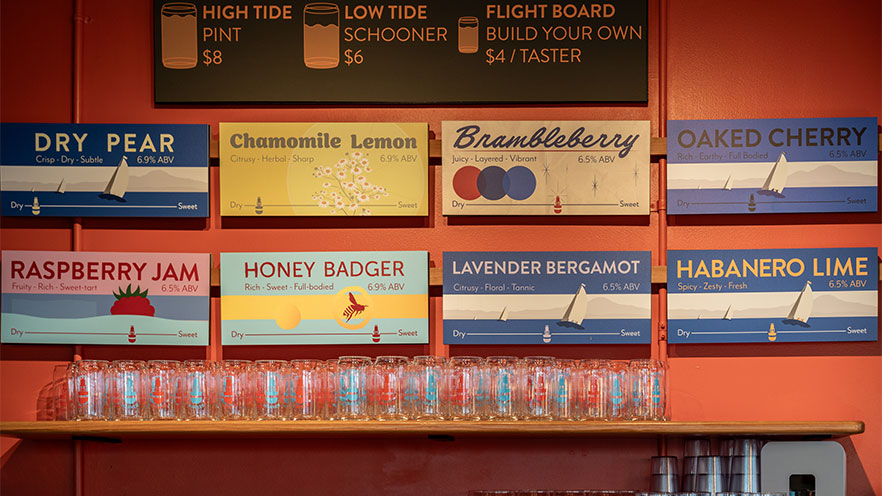 Channel Marker cider house varietals hanging on the wall.