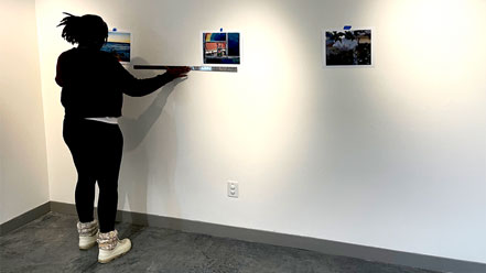 Asya Johnson sets up her gallery of work.