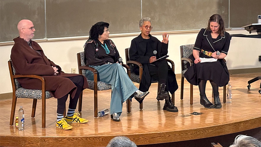 Rhonda Hill and Erik Reel host a panel discussion.