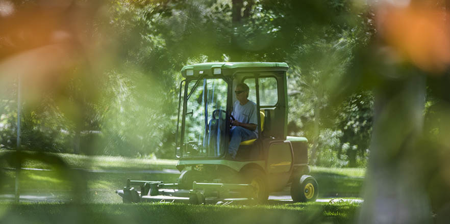 Man mowing the lawn at Whitman.