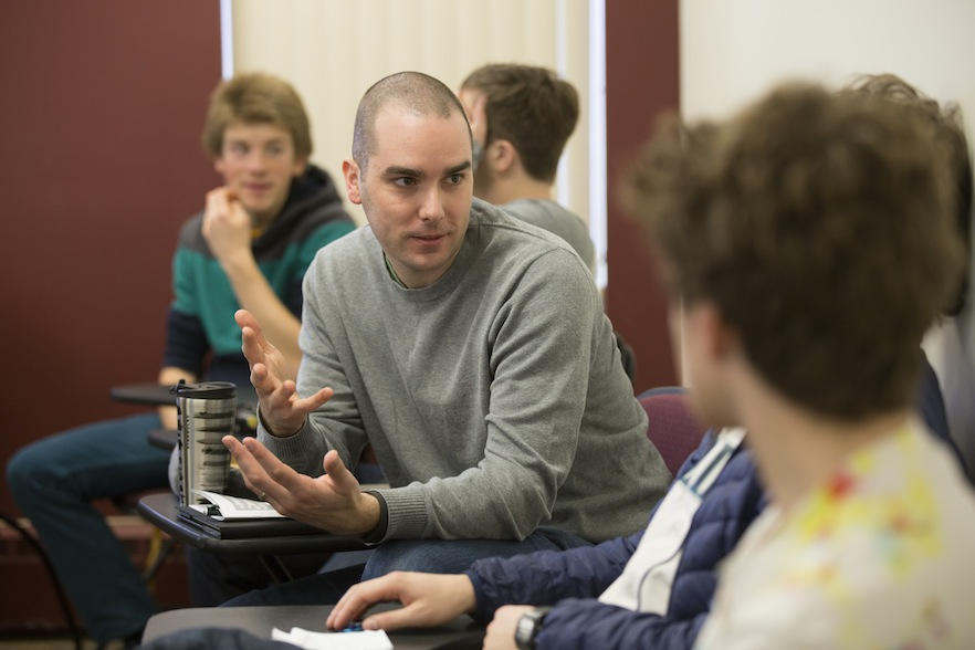 Students converse at symposium