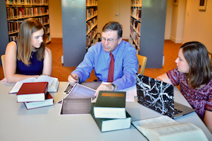 Schmitz with students in the library