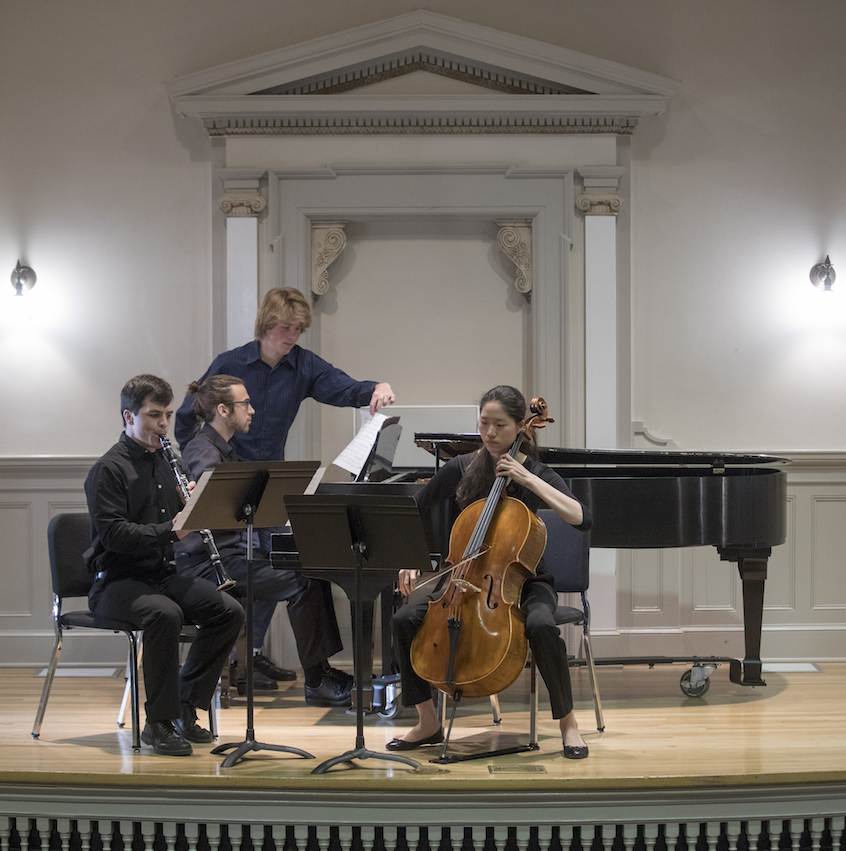 Thomas Meinzen '19 (center), an environmental humanities major and music minor, turns the pages on his composition, "Boundless: Theme and Variations for Cello, Clarinet and Piano," for the trio playing his work during Session I.